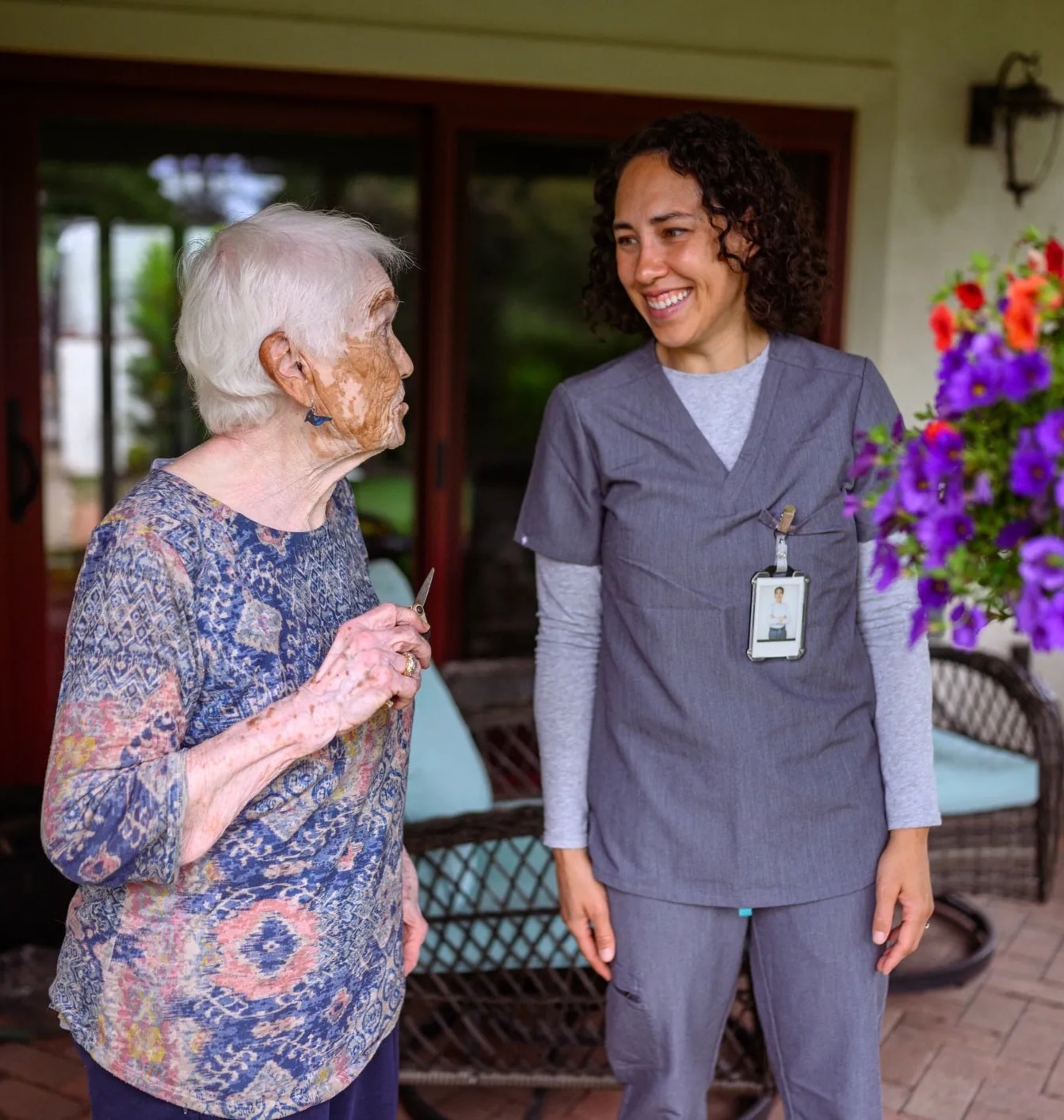 Caregiver and resident holding hands